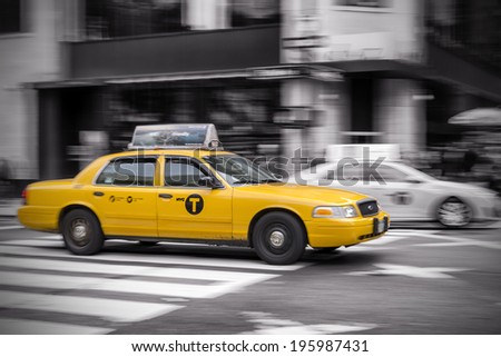 NEW YORK - OCTOBER 16: Panning shot of a NYC Taxi Cab at fifth avenue. New York City, on October 16, 2013.