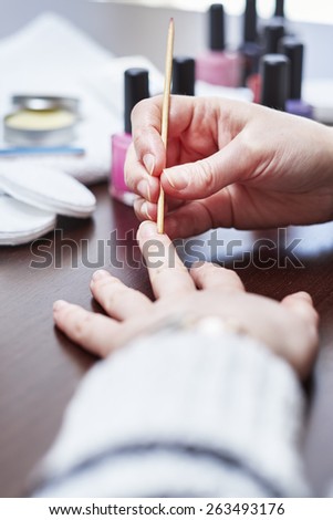 Woman having a manicure and painting her nails at home