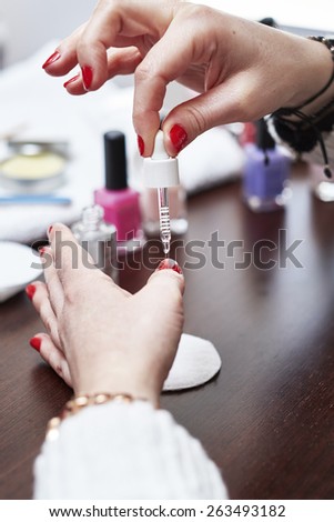 Woman having a manicure and painting her nails at home