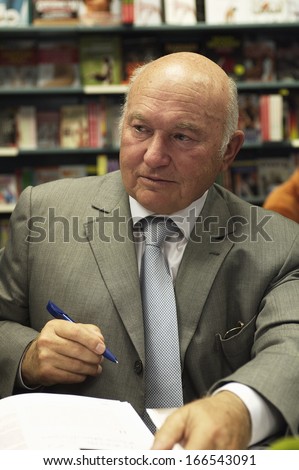 MOSCOW - SEPTEMBER 10: Former mayor of Moscow Yury Luzhkov signs copies of books about Moscow mayors, written by Nadezhda Polunina, in the Moscow House of Books on September 10, 2013 in Moscow.