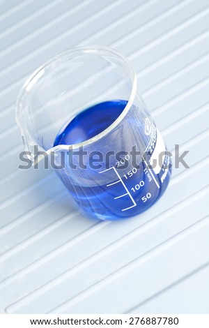 250ml measuring beaker filled with blue liquid