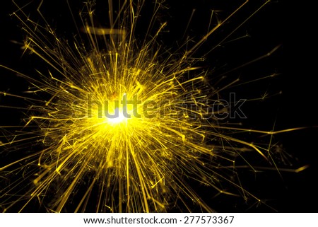 Bright yellow sparks from a sparkler