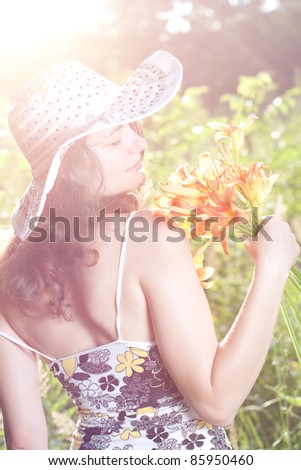 Portrait of beautiful female with flowers in hands