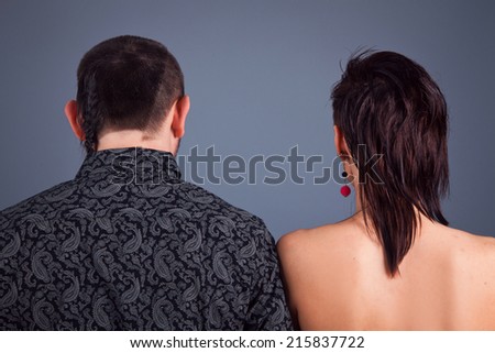 Man and woman are standing back