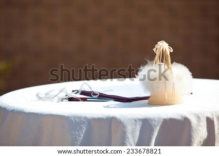 Marriage certificate and wedding rings at the altar
