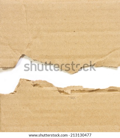 Hole ripped in corrugated cardboard on white background,with space for text or image.
