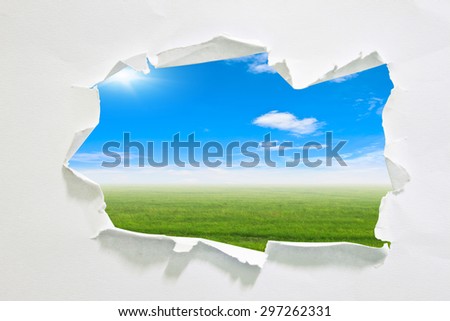 hole in paper with sky background inside