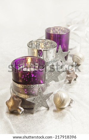 purple and silver storm lamps with Christmas balls