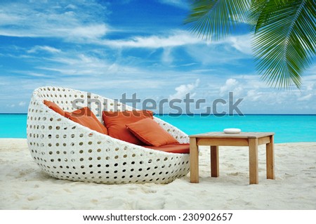 white orange lounge chair on the Maldivian beach