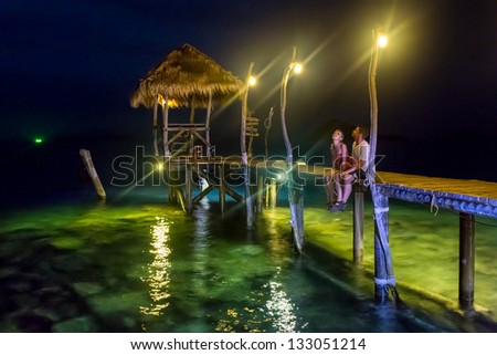 couple in love on the night romantic pier