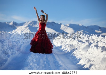 The girl on snow road to mountains