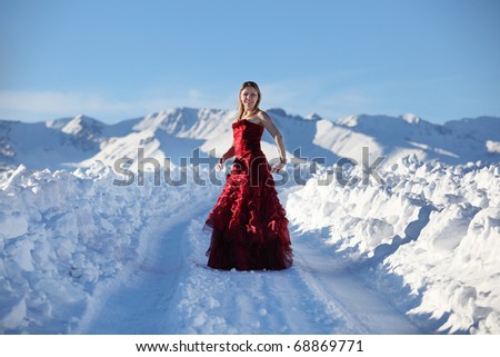 The girl in a red dress in mountains
