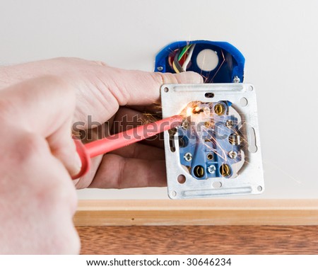Person mounting a live cord causing a short circuit