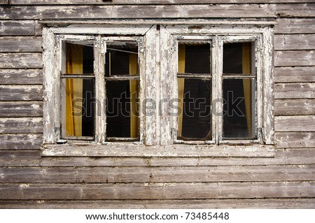 Two dark windows in old haunted house