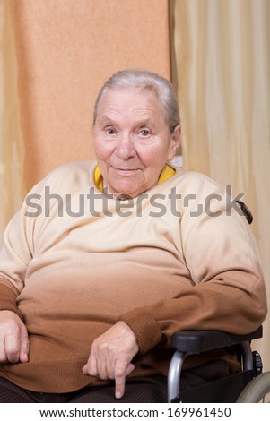 Eighty years old woman sitting in a wheelchair