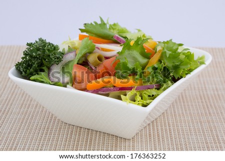 Bowl of healthy green garden salad with fresh vegetables