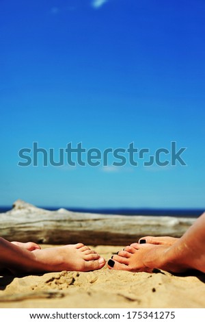 Woman and girls feet in the sand on the beach. mother and daughter feet.