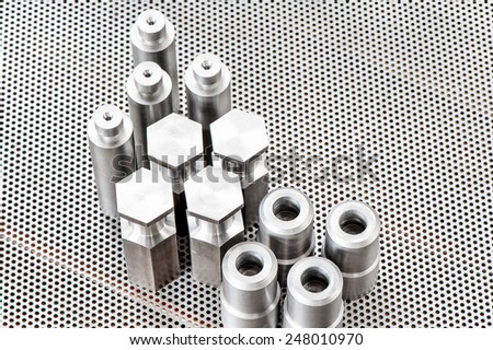Iron details - shafts bolts nuts and cylinders. Metal engineering. Lathe milling and drilling technology. CNC industry.