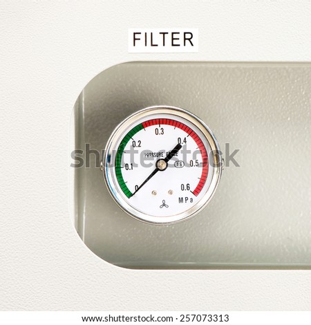 Industrial circle thermometer/manometer with temperature gauge. Arrow on zero. Indoors square close-up image.
