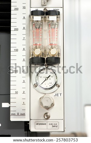 Industrial circle thermometer/manometer with temperature gauge. Arrow on zero. Indoors close-up.