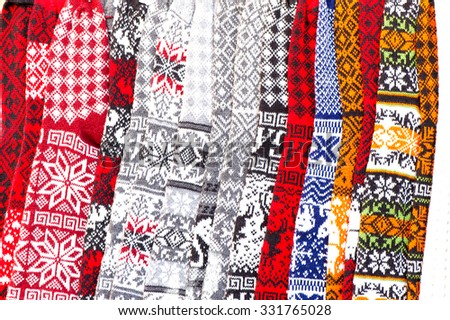 Ornamental national multicolored woolen knitted warm knee-high socks at market of Latvia. Multicolored horizontal image.
