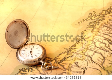 Ancient map with old silver pocket watch