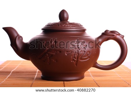 Classic chinese teapot on bamboo rug isolated on white