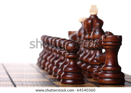 Wooden chess pieces on a chess board ready to battle. Isolated on white, shallow DOF