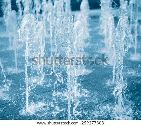 split tone blue stop motion fountain water in the garden
