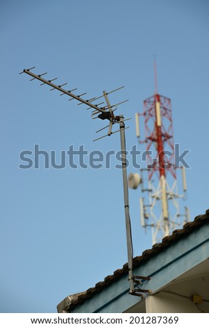 old TV antenna on cell phone signal station background