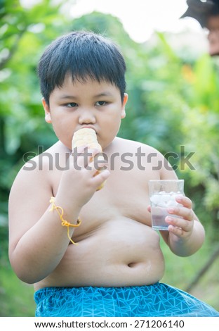 cute fat boy with bread on nature background