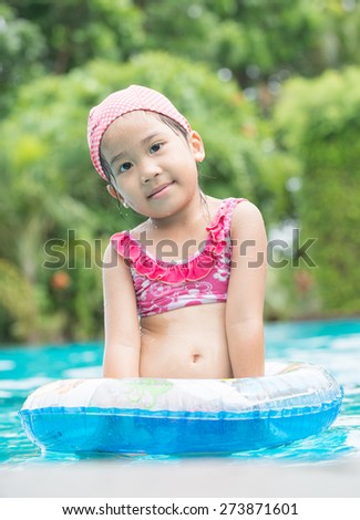Little cute Asian girl on bikini suit