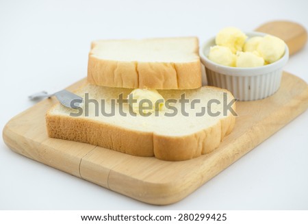 fresh butter on bread isolated on white
