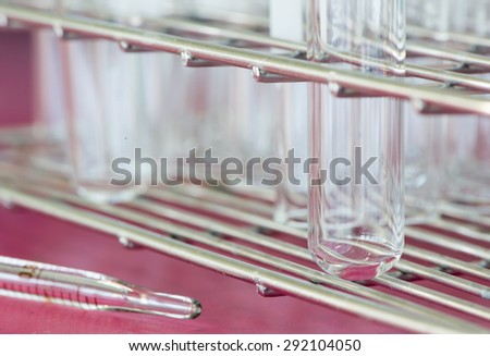test tube on steel basket on red background