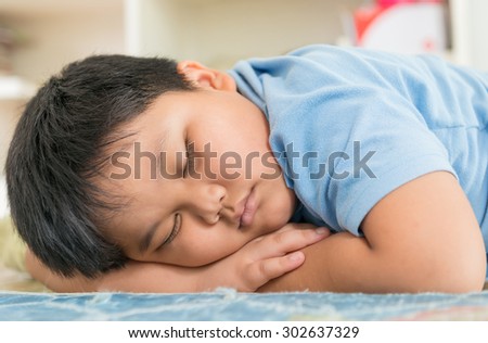 Fat boy sleep dream on his arm.