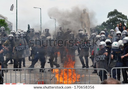 ATHENS, GREECE -JUNE15. A molotov explodes next to riot police at the Greek Parliament during demonstration , in Athens, June 15, 2011.