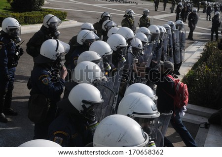 ATHENS, GREECE-FEB.23. Pushing against riot police shields. During demonstration in Athens, February 23, 2011.