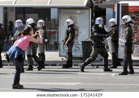 Athens, Greece-Feb. 24 Girl Photographing Riot Police, During Demonstration, In Central Athens, February 24, 2010.