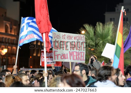 Athens, Greece Jan. 25, 2015 Supporters of Syriza left wing party with flags outside Athens University. The baner says:\