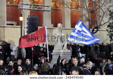 Athens, Greece Jan. 25, 2015.Supporters of Syriza left wing party with Greek blue flag and Syriza`s red outside Athens University. Syriza, won Sunday\'s general election.