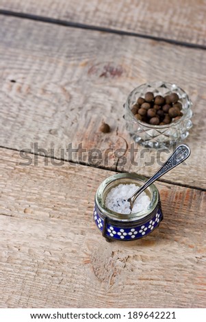 Salt-cellar and a pepper on the wooden table