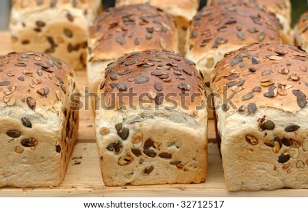 Bread with pumpkin seeds lay on the table.