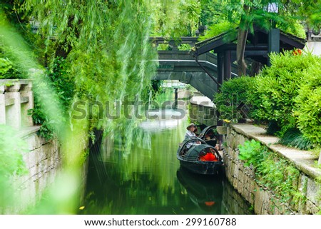 SHAOXING, CHINA - July 3, 2015: A boat man resting in the traditional row boat in Shaoxing City, Jiangsu Province, China on July 3, 2015