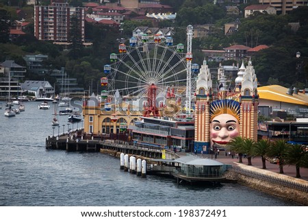 SYDNEY,AUSTRALIA - FEBRUARY 11, 2014: The Luna Park funfair and Milsons Point ferry wharf. Luna Park opened in 1935 and is protected by government legislation.