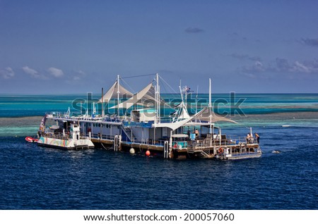 GREAT BARRIER REEF, AUSTRALIA - October 14,2013: Staff perform end-of-day tasks on the Reefworld pontoon. Visitors can snorkel, dive, ride a semi-submersible or stay overnight under the stars.