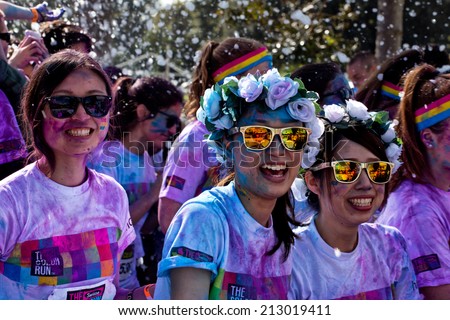 SYDNEY,AUSTRALIA - AUGUST 24,2014: Competitors in the 'Color Run' fun run in Centennial Park. Runners are doused in coloured powder, bubbles and water as they run the 5K course.