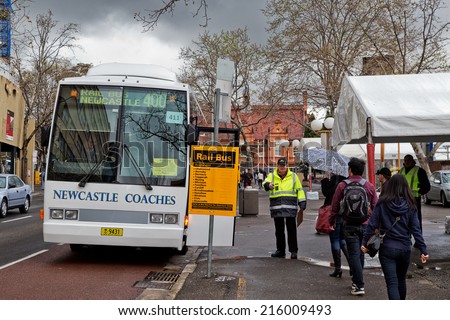 SYDNEY,AUSTRALIA - SEPTEMBER 7, 2014: Rail passengers board a replacement bus for their journey to Newcastle. Railways are frequently closed at weekends for maintenance, with buses replacing trains.