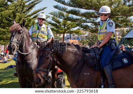 COOGEE,AUSTRALIA - SEPTEMBER 28,2014: Mounted police and their horses at a beach soccer tournament between police and international students.