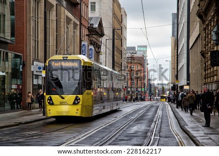 MANCHESTER,ENGLAND- OCTOBER 8,2014: A tram on the Metrolink light rail system makes its way down Mosley Street