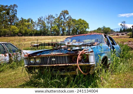 GLENORIE,AUSTRALIA - DECEMBER 29,2014: Vintage Ford cars lie abandoned and derelict in a field. The landowner is happy to just mow the grass around them.